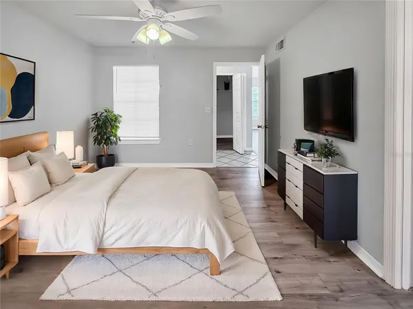 a bedroom with a large bed and a flat screen tv