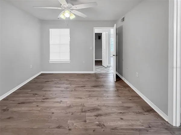 wooden floor in an empty room with a window