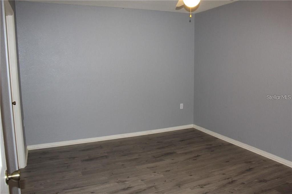 5017 City Street, Unit 1933 Orlando, FL 32839 - Photo 6 of 12 a view of an empty room with wooden floor