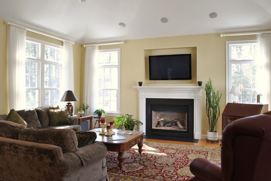 119 Crescent Road Concord, MA 01742 - Photo 4 of 18 a living room with furniture a flat screen tv and a fireplace