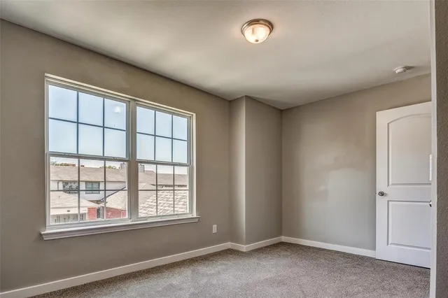 a bathroom with a granite countertop sink a toilet a mirror and shower