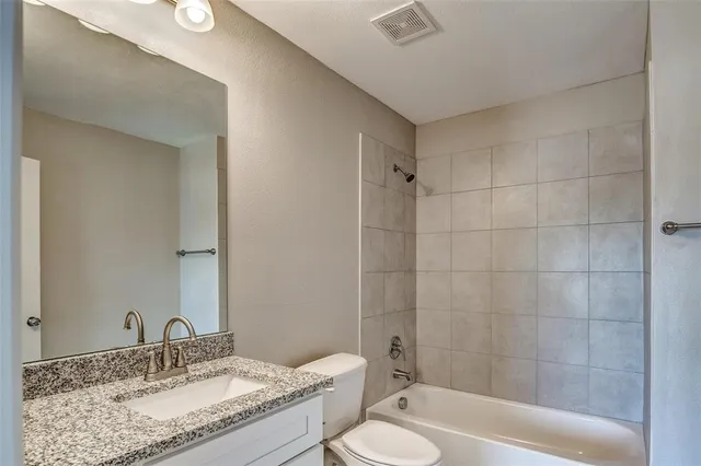 an empty room with a ceiling fan