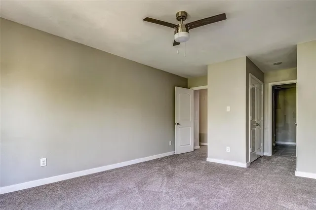 a bathroom with a granite countertop sink and a bathtub with shower