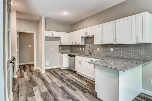 a kitchen with stainless steel appliances granite countertop a sink stove and cabinets