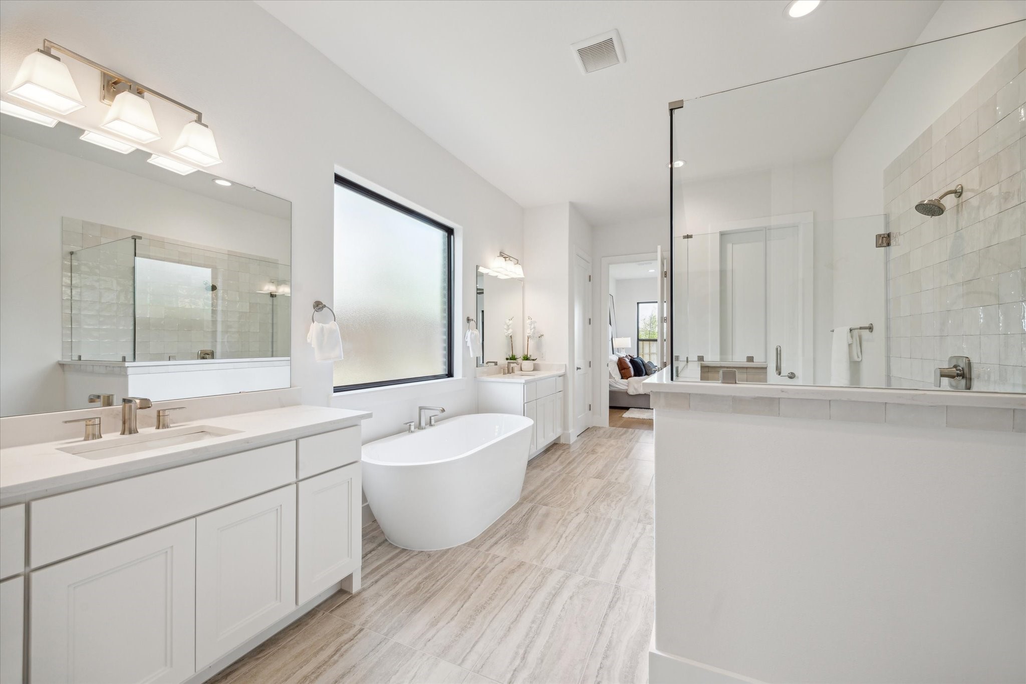 403 Venado View Court Conroe, TX 77304 - Photo 14 of 44 Primary Bath has separate vanities, deep soaking bathtub, walk-in shower, and 2 closets!