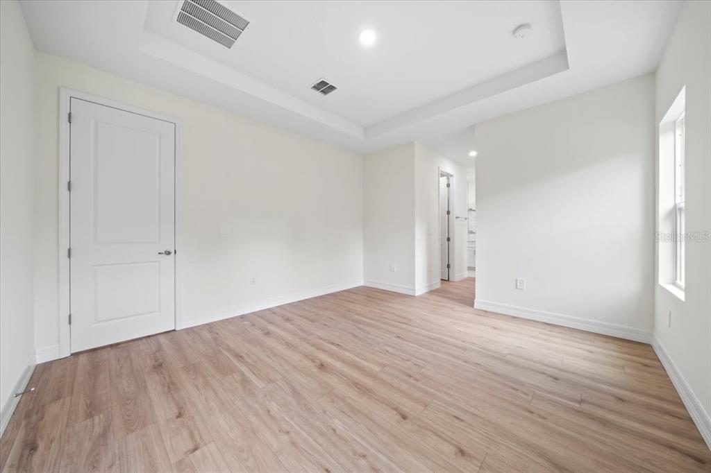 5094 Hightower Road North Port, FL 34288 - Photo 17 of 23 an empty room with wooden floor and windows