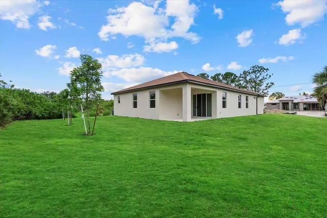 a view of a house with a backyard