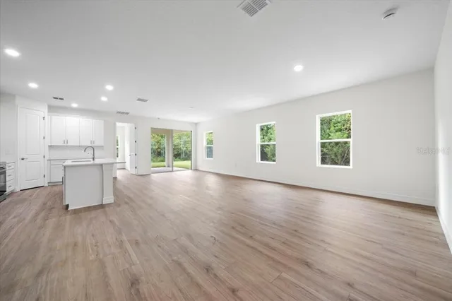 a kitchen with a refrigerator a sink and cabinets