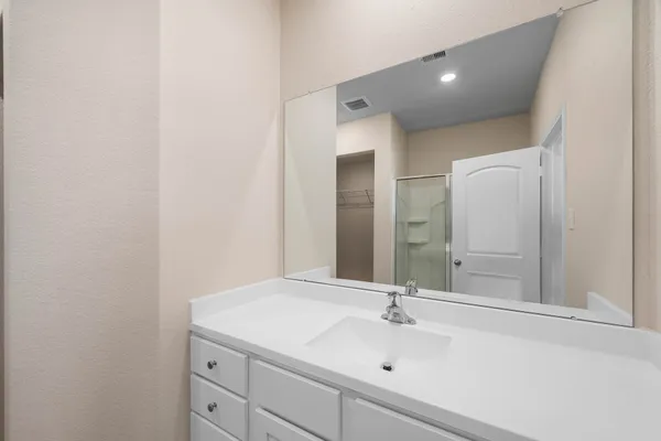 a bathroom with a glass shower door