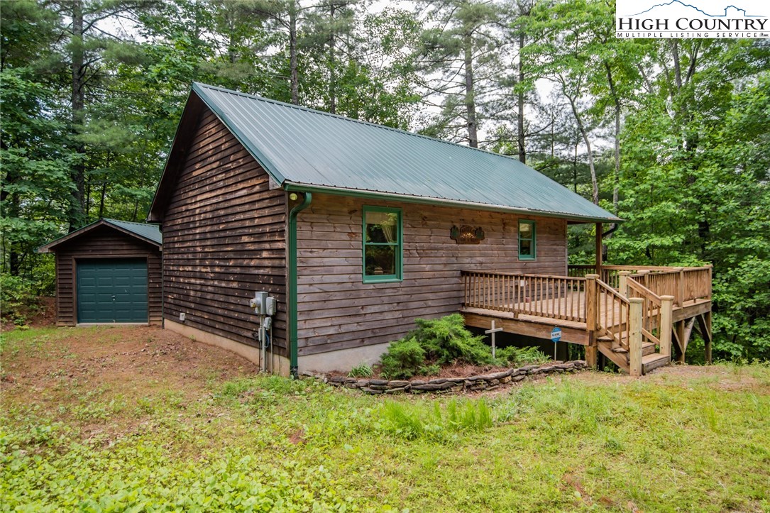 605 Wolf Pen Road Purlear, NC 28665 - Photo 1 of 50 a view of a house with wooden fence and a yard