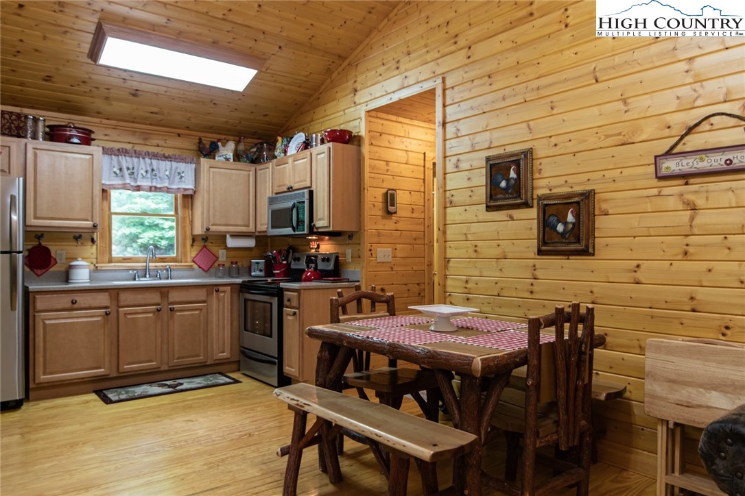 605 Wolf Pen Road Purlear, NC 28665 - Photo 14 of 50 a view of a kitchen with a table and chairs in it