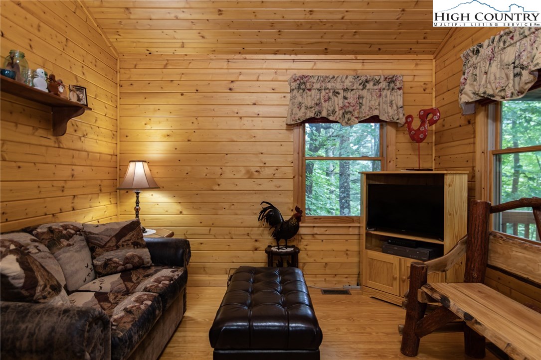 605 Wolf Pen Road Purlear, NC 28665 - Photo 15 of 50 a living room with furniture and a flat screen tv