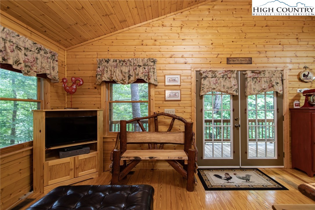 605 Wolf Pen Road Purlear, NC 28665 - Photo 19 of 50 a living room with furniture floor to ceiling window and a flat screen tv