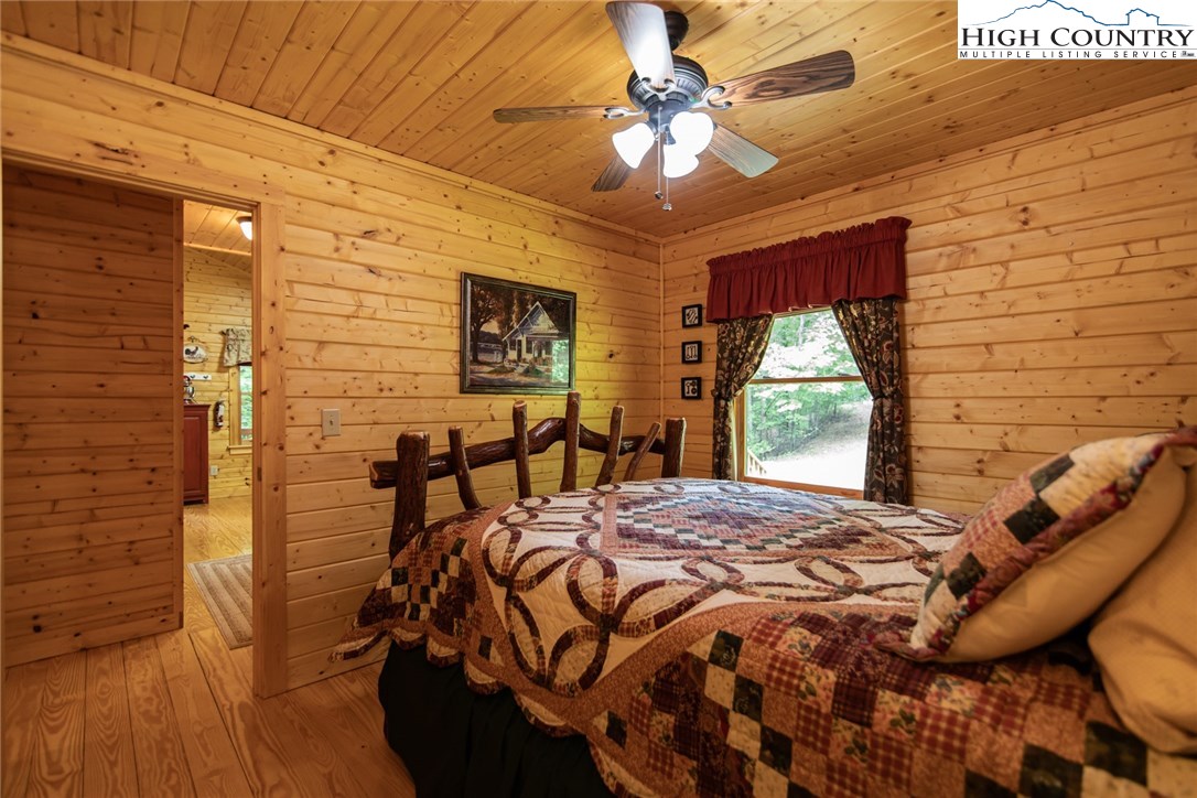 605 Wolf Pen Road Purlear, NC 28665 - Photo 23 of 50 a bed sitting in a bedroom next to a window