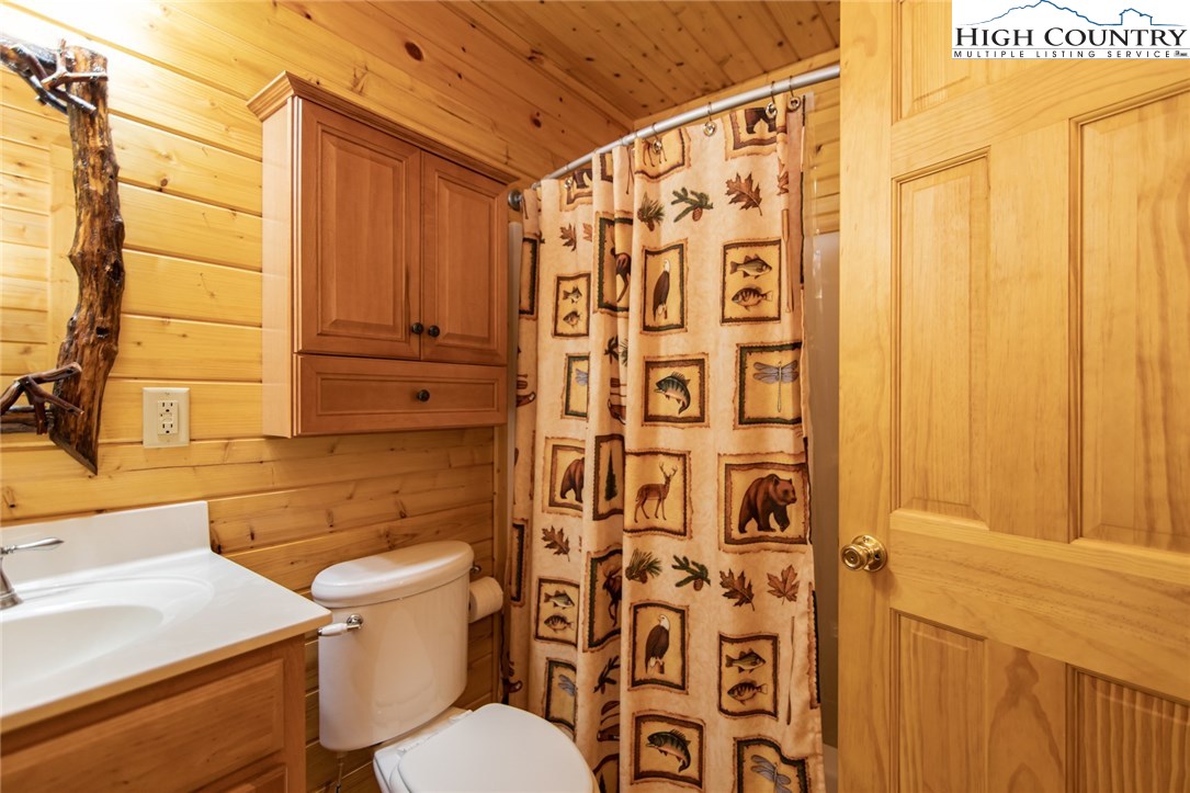 605 Wolf Pen Road Purlear, NC 28665 - Photo 25 of 50 a bathroom with a shower curtain and a sink