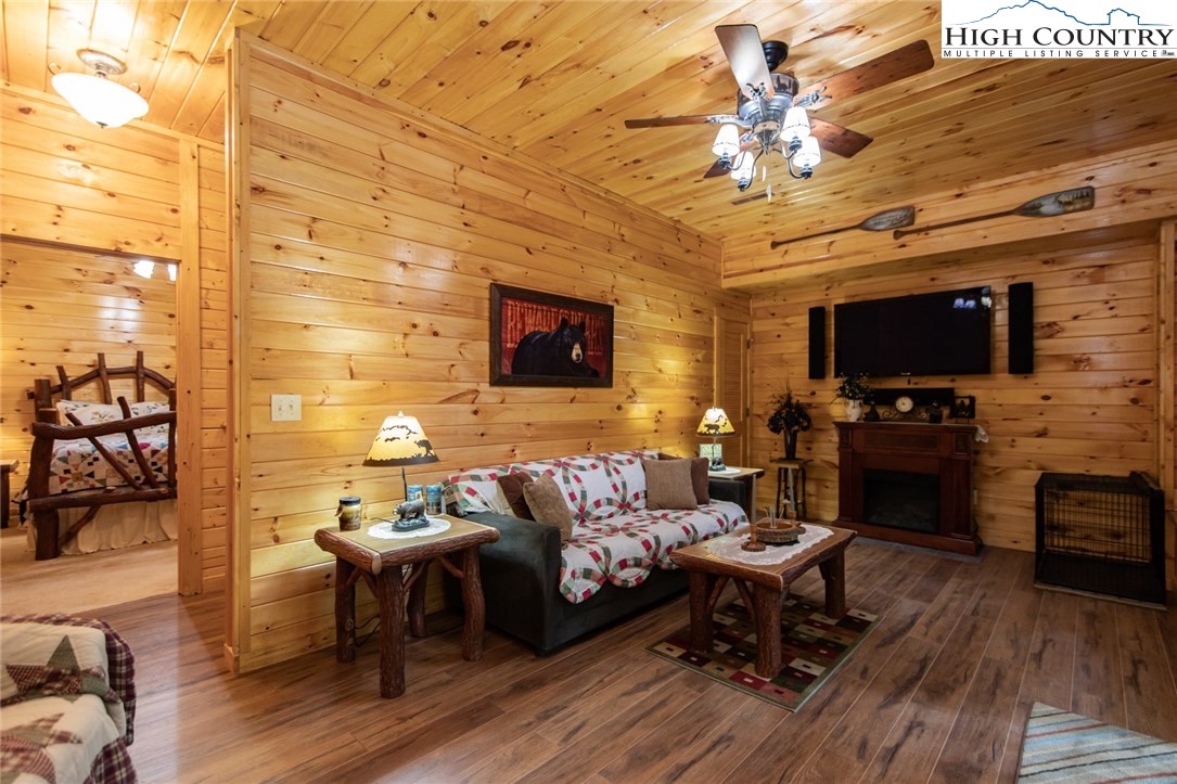 605 Wolf Pen Road Purlear, NC 28665 - Photo 29 of 50 a living room with furniture a flat screen tv and kitchen view