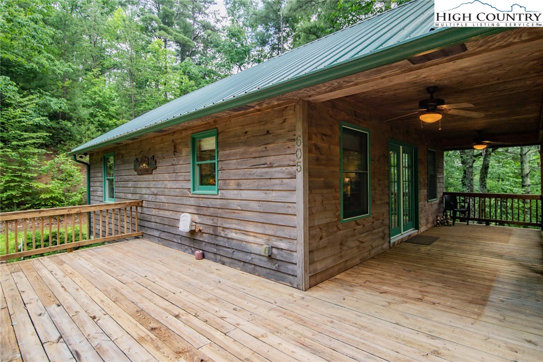 605 Wolf Pen Road Purlear, NC 28665 - Photo 3 of 50 a view of a house with a wooden deck