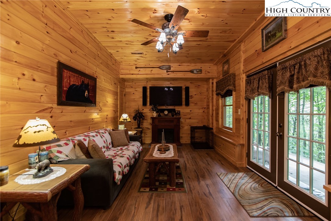 605 Wolf Pen Road Purlear, NC 28665 - Photo 36 of 50 a living room with furniture a flat screen tv and a fireplace