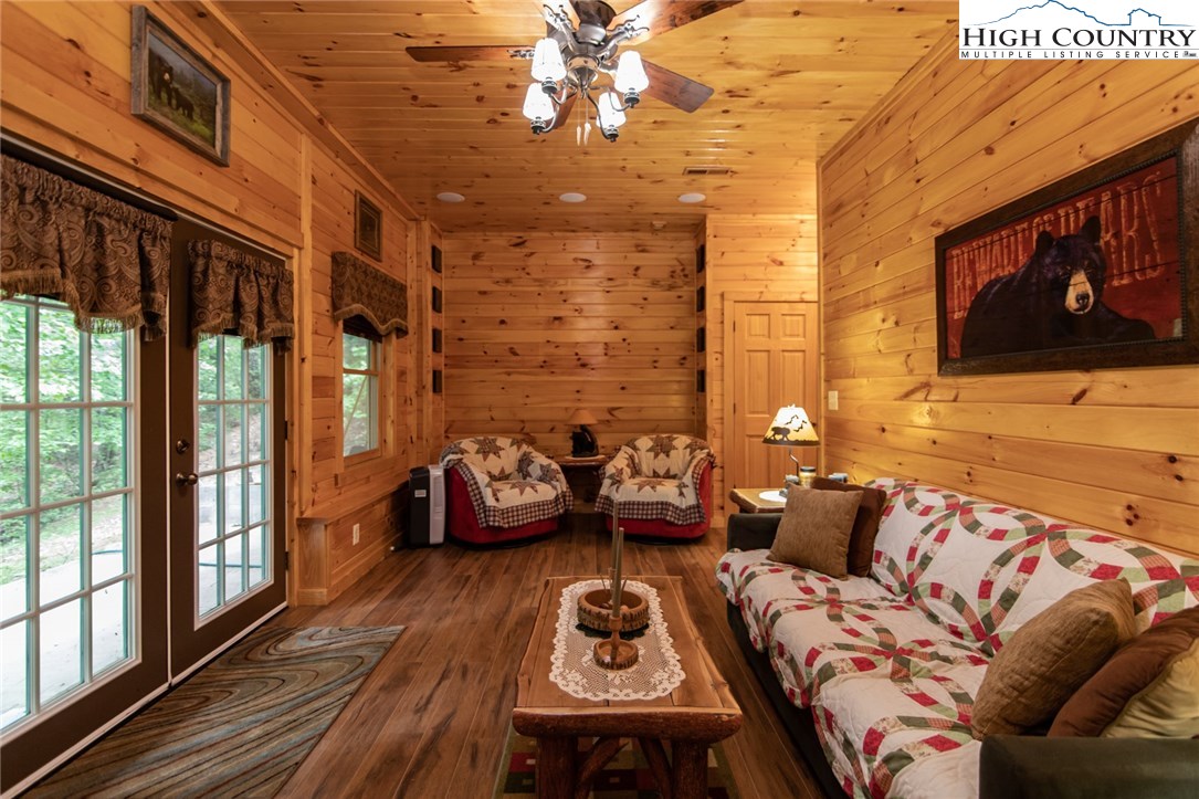 605 Wolf Pen Road Purlear, NC 28665 - Photo 38 of 50 a living room with furniture and a floor to ceiling window