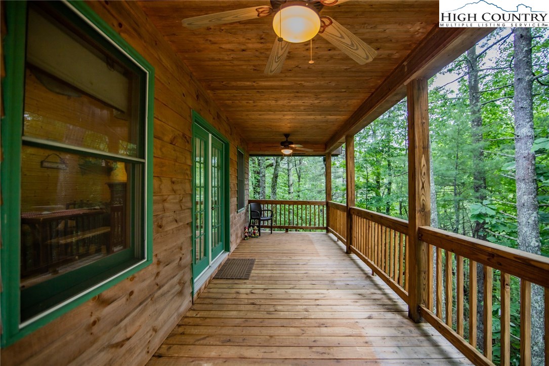 605 Wolf Pen Road Purlear, NC 28665 - Photo 4 of 50 a view of a porch with wooden floor