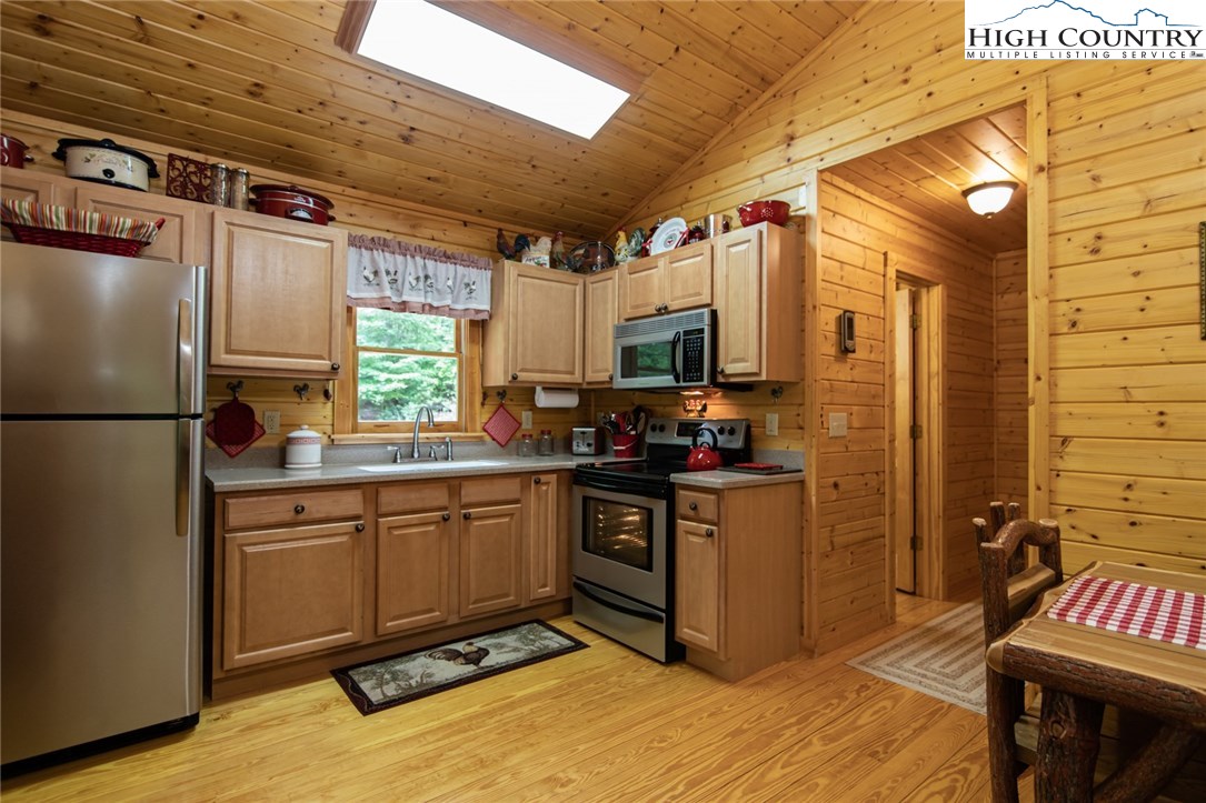 605 Wolf Pen Road Purlear, NC 28665 - Photo 7 of 50 a kitchen with stainless steel appliances granite countertop a stove a sink dishwasher and a refrigerator