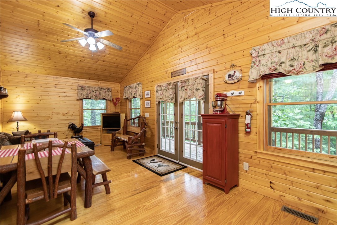 605 Wolf Pen Road Purlear, NC 28665 - Photo 10 of 50 a living room with furniture a fireplace and a flat screen tv