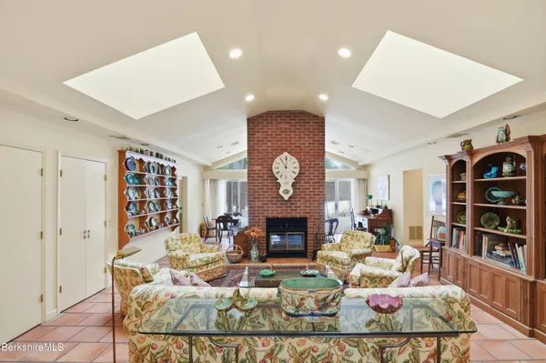 a living room with fireplace furniture and a fireplace