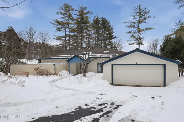 a view of a house with a snow in the yard