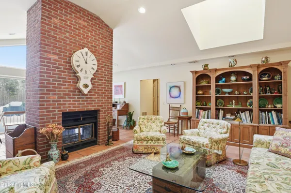 a living room with furniture a chandelier and a window