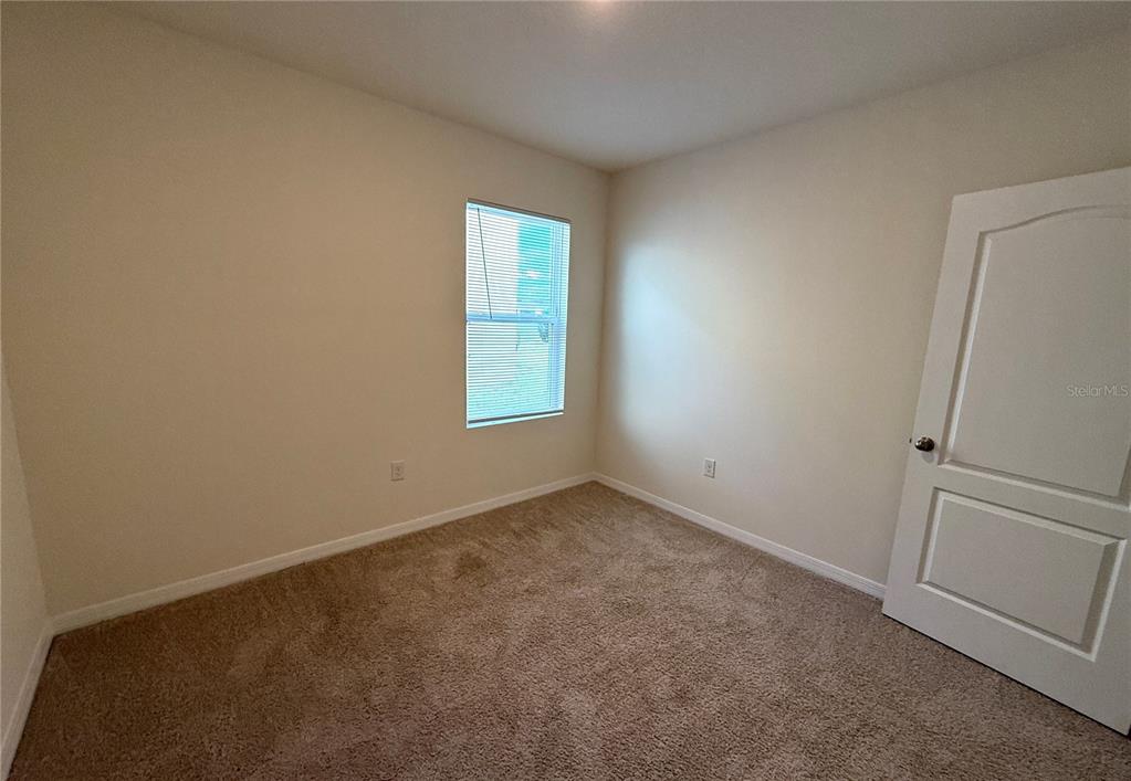 2877 Sunridge Loop St. Cloud, FL 34771 - Photo 14 of 19 an empty room with windows