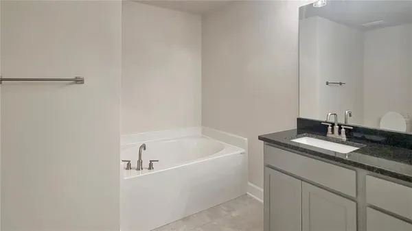 a bathroom with a granite countertop sink and mirror