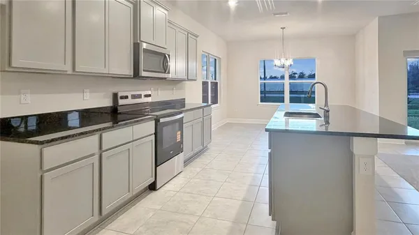 a kitchen with stainless steel appliances granite countertop a sink and cabinets