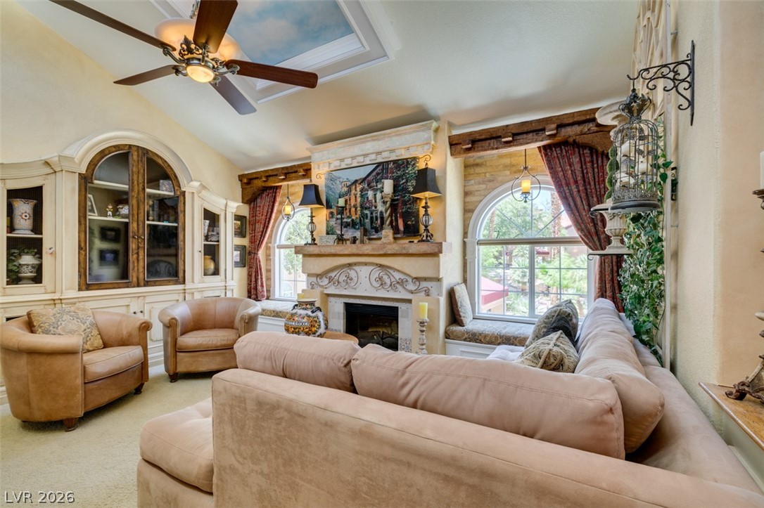 9325 West Desert Inn Road, Unit 244 Las Vegas, NV 89117 - Photo 7 of 55 Ornate fireplace and arched windows create a cozy, inviting atmosphere.