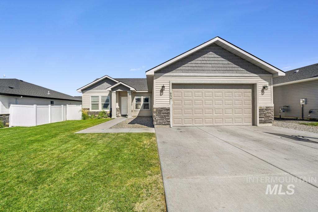 934 Trinity Road Jerome, ID 83338 - Photo 1 of 1 Craftsman-style home with stone siding, concrete driveway, and a garage