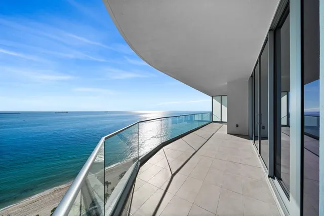 a view of a balcony next to an ocean view