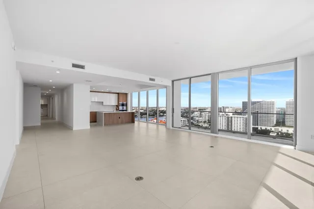 a view of a living room hardwood floor and a kitchen