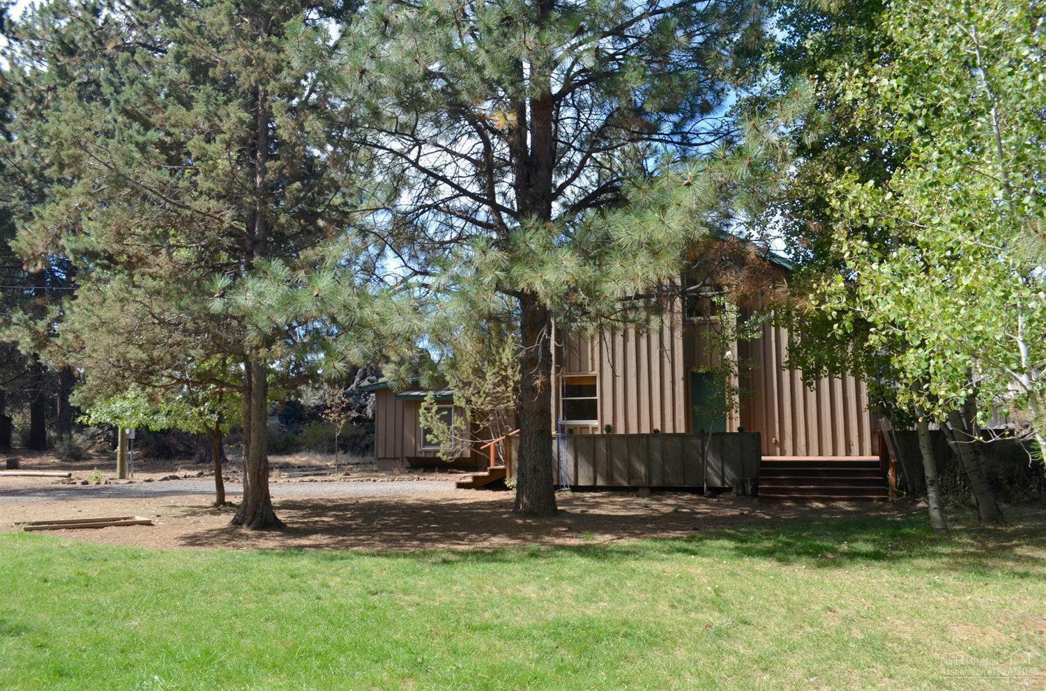 60197 Turquoise Road Bend, OR 97702 - Photo 2 of 23 Front yard is grassy mature aspen and po
