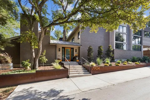 front view of a house with a tree in front