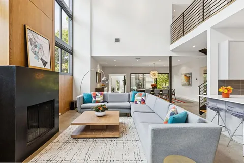 a living room with furniture fireplace and rug