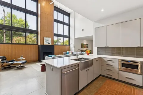 a kitchen that has a sink and a stove in it