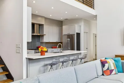 a kitchen with stainless steel appliances a refrigerator and a sink