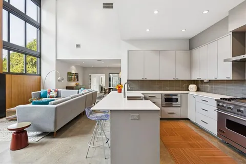 a kitchen with sink a stove and furniture