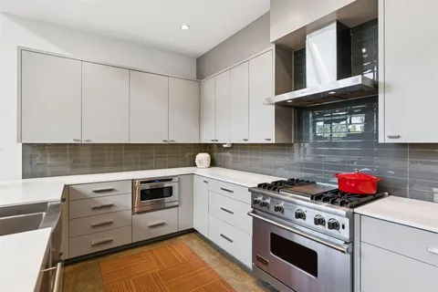 a kitchen with cabinets appliances and a sink