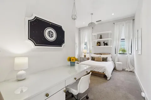 a bedroom with bed and window