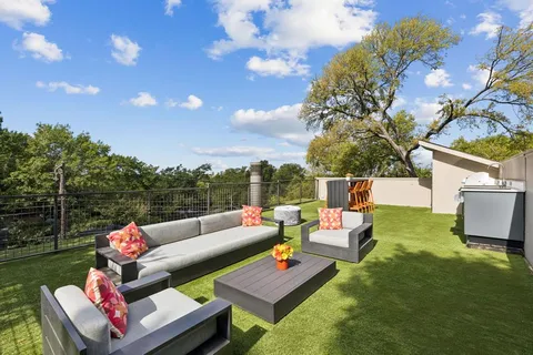a outdoor living space with furniture and a flat screen tv