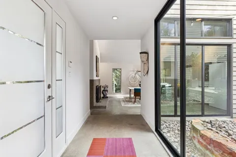 a hallway with a view of living room