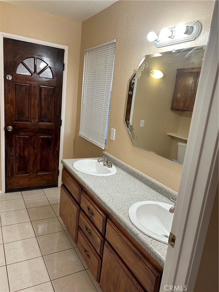 58481 Del Mar Street Yucca Valley, CA 92284 - Photo 25 of 29 a bathroom with a sink a vanity and a mirror