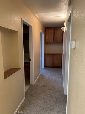 a view of a hallway to closet and utility room