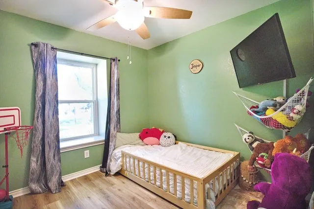 a bedroom with a bed and a window