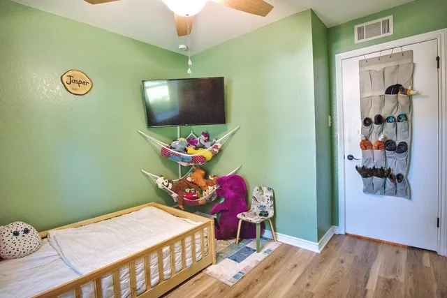 a bedroom with a bed and a flat screen tv